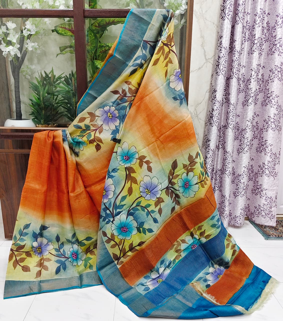 Radiant Hand-Painted Zari Border Gachi Tussar Silk Saree – Multishade Ombre with Blue Floral Design